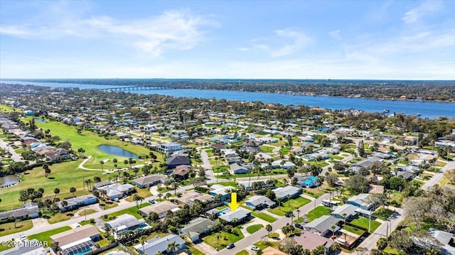 birds eye view of property with a residential view, view of golf course, and a water view