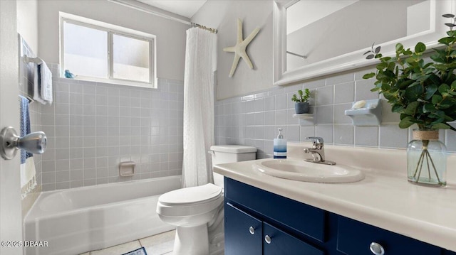 bathroom featuring tile walls, toilet, shower / tub combo, vanity, and tile patterned flooring