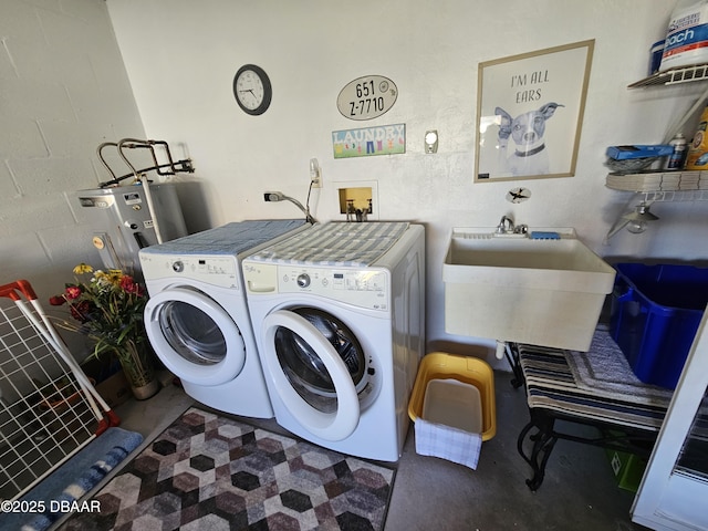 clothes washing area with sink, independent washer and dryer, and water heater