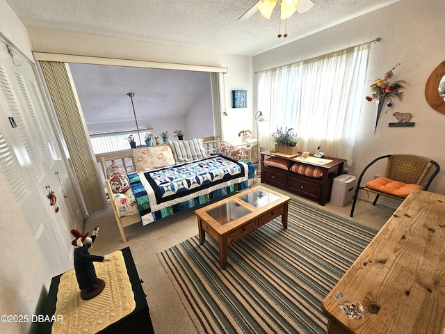 bedroom featuring a textured ceiling, ceiling fan, a closet, and carpet floors