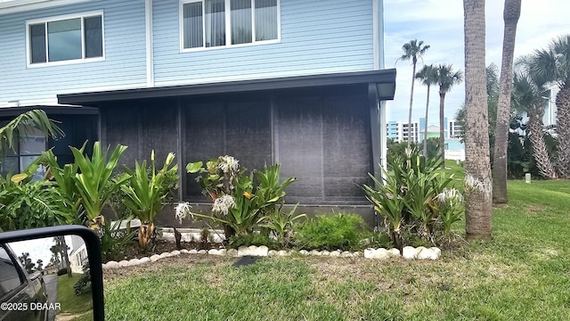 55 Chippingwood Ln, Ormond Beach, FL 32176 - view of side of home with a lawn and a sunroom