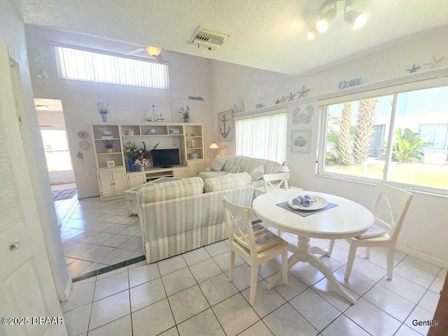55 Chippingwood Ln, Ormond Beach, FL 32176 - dining space with light tile patterned flooring and a textured ceiling