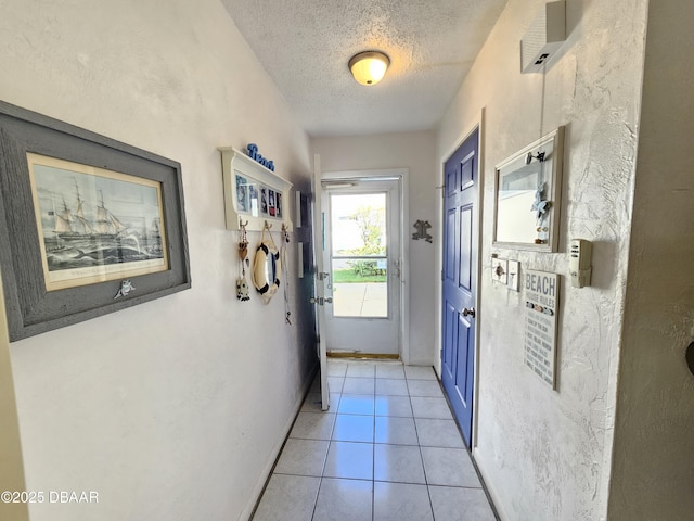 entryway featuring a textured ceiling and light tile patterned floors