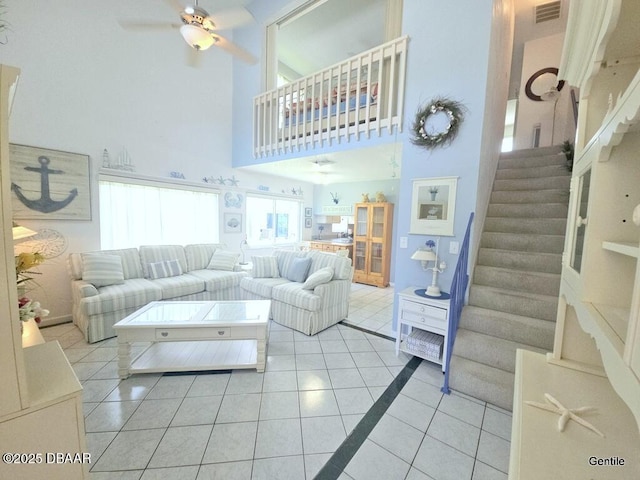 55 Chippingwood Ln, Ormond Beach, FL 32176 - living area with a ceiling fan, light tile patterned flooring, stairway, and a high ceiling