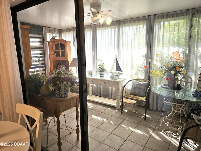 sunroom / solarium featuring ceiling fan and a healthy amount of sunlight