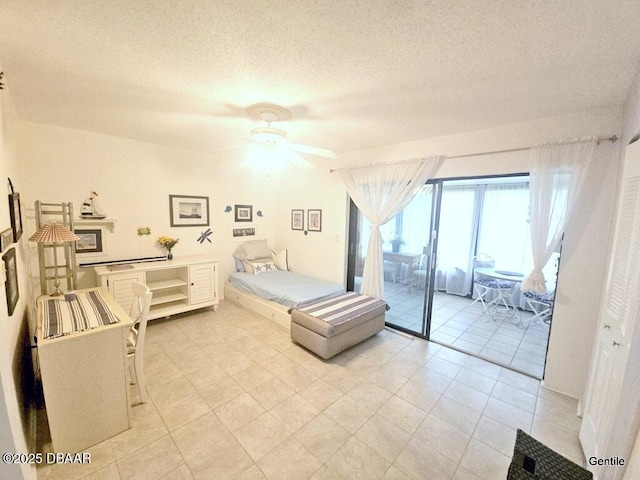 55 Chippingwood Ln, Ormond Beach, FL 32176 - bedroom with access to outside, a textured ceiling, light tile patterned flooring, and a ceiling fan