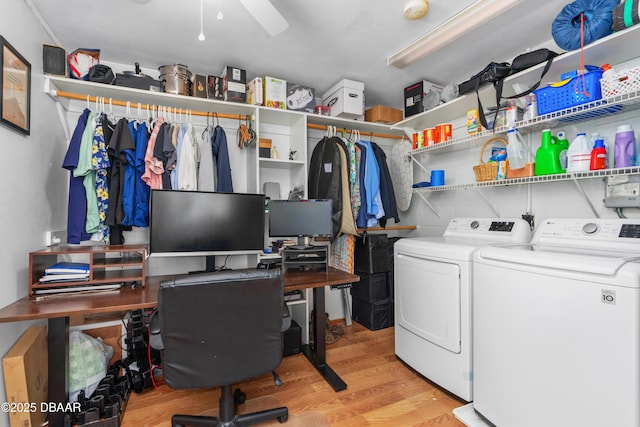 laundry area featuring ceiling fan, washing machine and clothes dryer, and light hardwood / wood-style floors