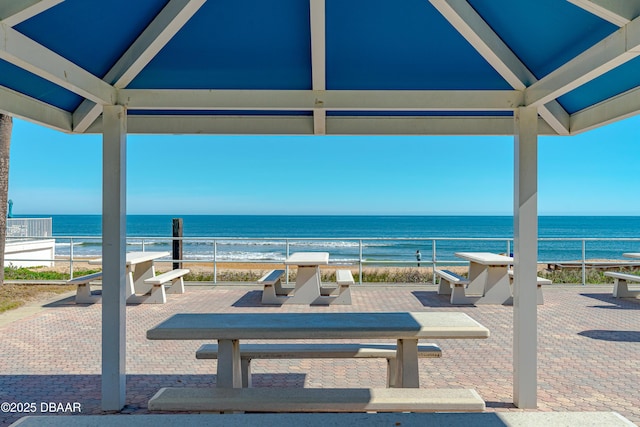 exterior space featuring a water view and a beach view