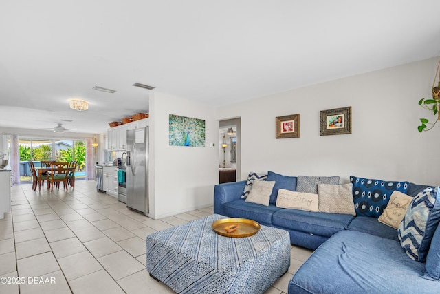 tiled living room with ceiling fan