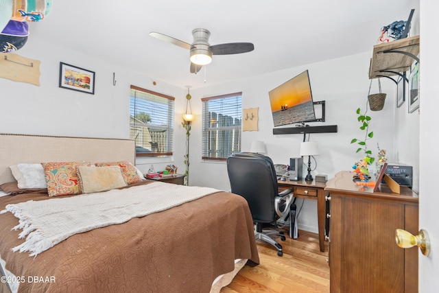 bedroom with ceiling fan and light hardwood / wood-style flooring