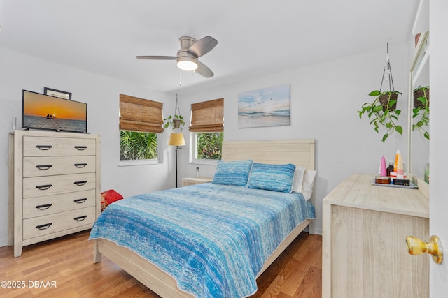 bedroom with wood-type flooring and ceiling fan