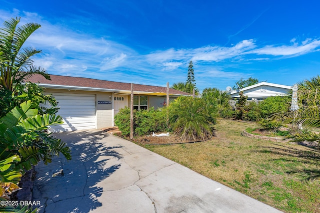 single story home featuring a garage and a front yard