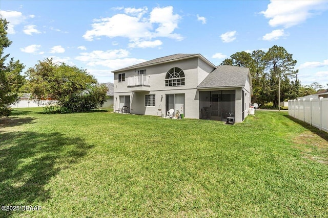 21 Whittingham Ln, Palm Coast, FL 32164 - back of property featuring stucco siding, fence, a yard, and a balcony
