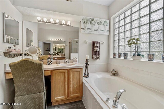 21 Whittingham Ln, Palm Coast, FL 32164 - bathroom with a shower stall, a garden tub, and vanity