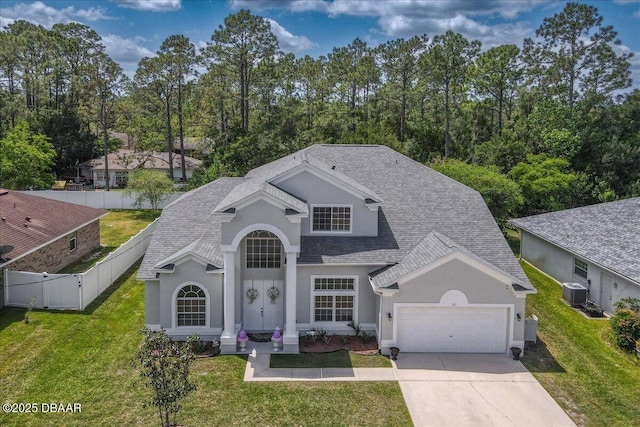 21 Whittingham Ln, Palm Coast, FL 32164 - view of front facade featuring roof with shingles, a front lawn, concrete driveway, a garage, and stucco siding