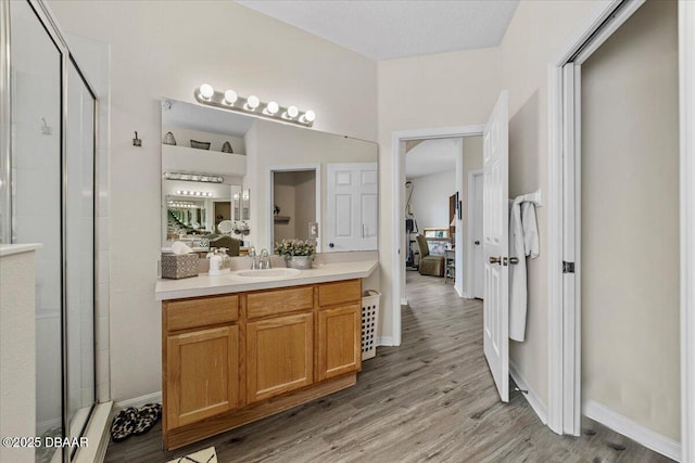 21 Whittingham Ln, Palm Coast, FL 32164 - bathroom featuring connected bathroom, a shower stall, vanity, and wood finished floors