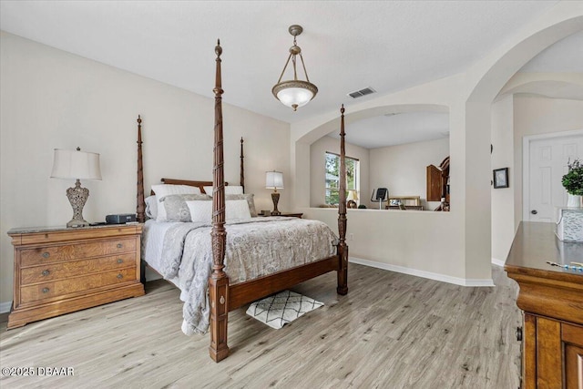 21 Whittingham Ln, Palm Coast, FL 32164 - bedroom featuring visible vents, baseboards, wood finished floors, and arched walkways