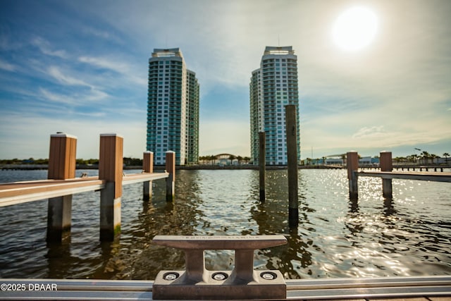 view of dock featuring a water view and a city view