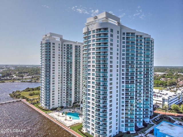 view of building exterior featuring a water view and a city view