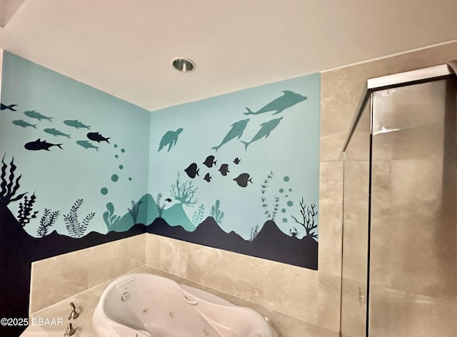 bathroom with a tub with jets