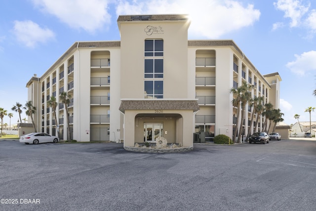 view of building exterior with uncovered parking