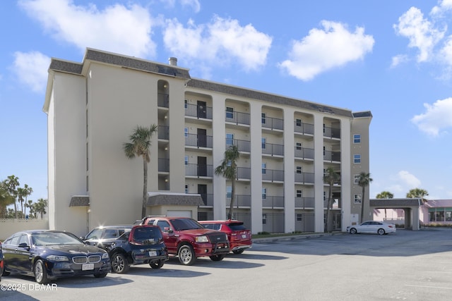 view of property featuring uncovered parking