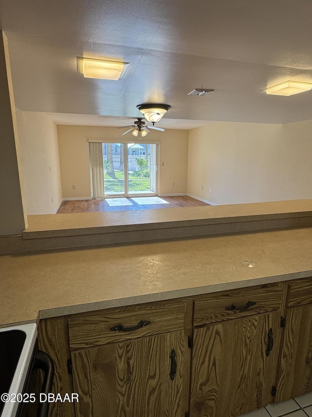 kitchen with ceiling fan and light tile patterned flooring