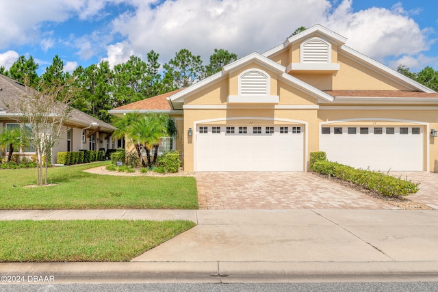 view of front of home with a garage and a front yard