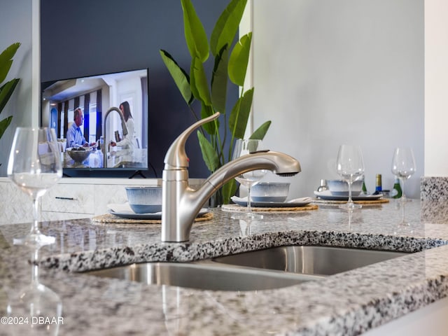 room details featuring sink and stone countertops