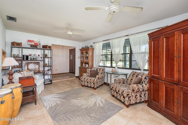 living area featuring ceiling fan and light tile patterned floors