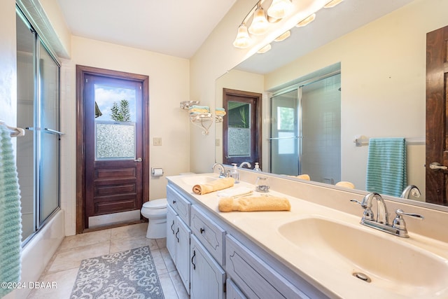 full bathroom featuring tile patterned flooring, vanity, toilet, and enclosed tub / shower combo