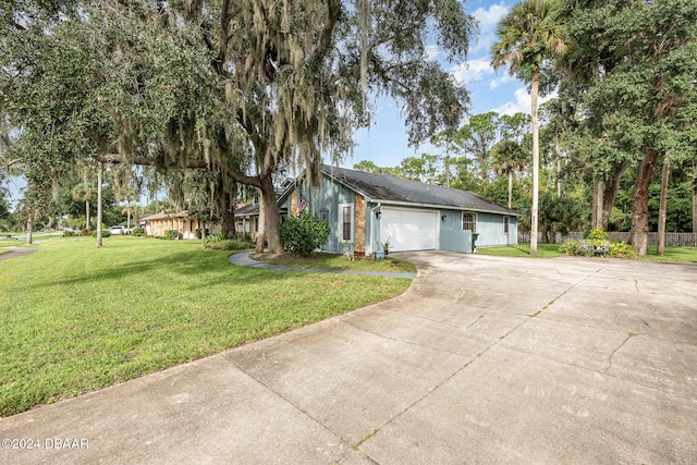 ranch-style house featuring a front yard and a garage