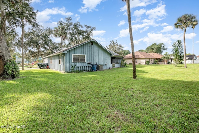 view of side of property with a lawn