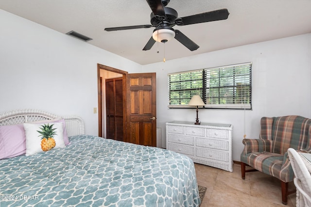 tiled bedroom with ceiling fan