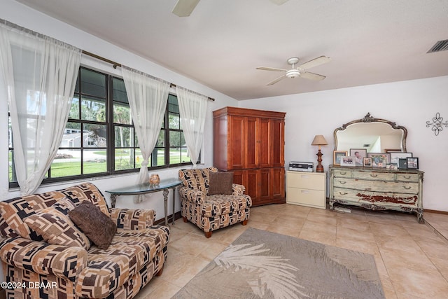 living area featuring ceiling fan and light tile patterned floors