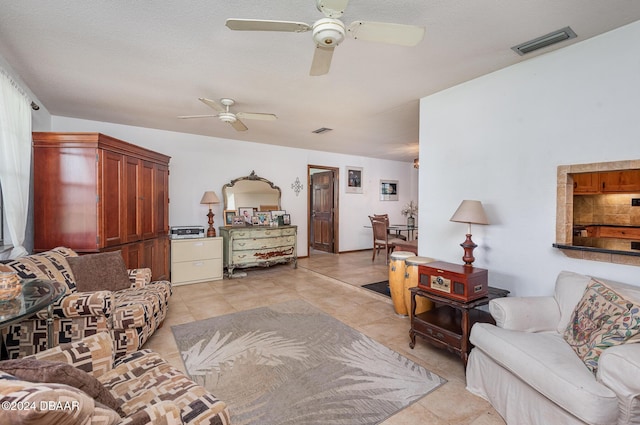 tiled living room featuring ceiling fan