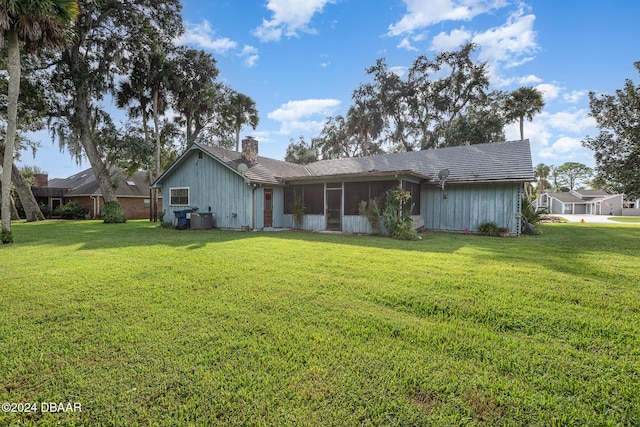 back of house featuring a yard, central AC, and a sunroom