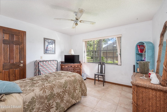 bedroom featuring light tile patterned floors, a textured ceiling, and ceiling fan