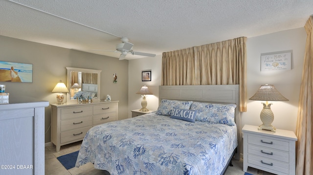 bedroom featuring a textured ceiling, light tile patterned floors, and ceiling fan