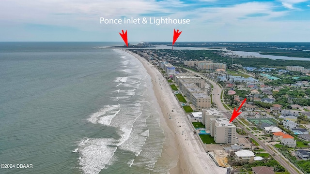 bird's eye view featuring a view of the beach and a water view