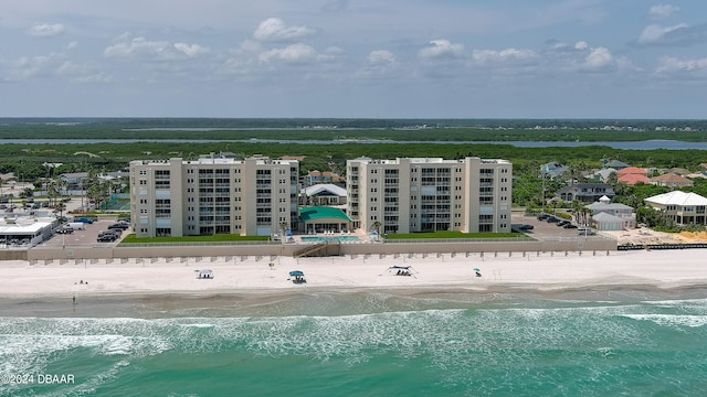 drone / aerial view with a beach view and a water view