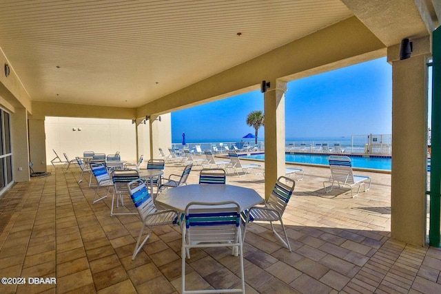 view of patio featuring a water view and a community pool