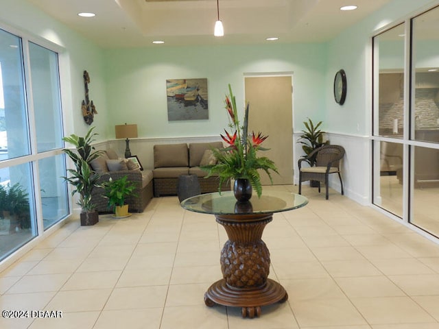 tiled living room with a tray ceiling