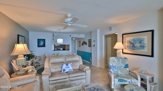 tiled living room featuring a textured ceiling and ceiling fan