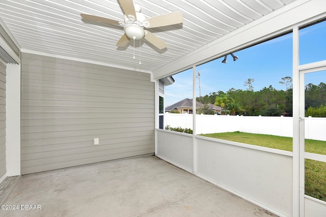 unfurnished sunroom featuring ceiling fan