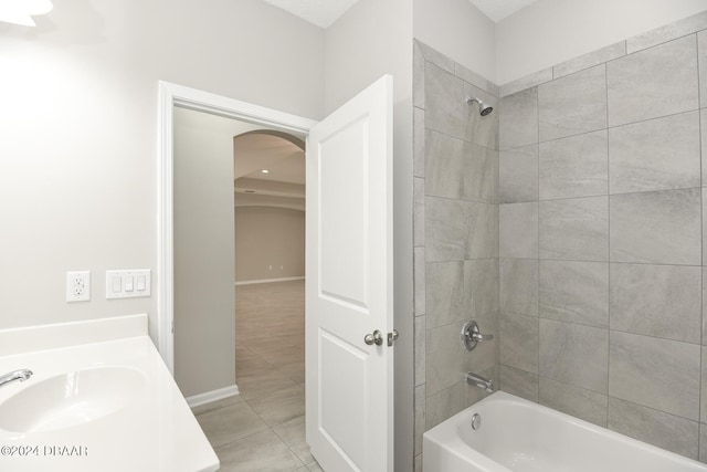 bathroom with tile patterned floors, tiled shower / bath combo, and vanity