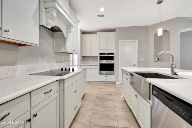 kitchen featuring appliances with stainless steel finishes, custom range hood, light tile patterned floors, decorative light fixtures, and white cabinetry