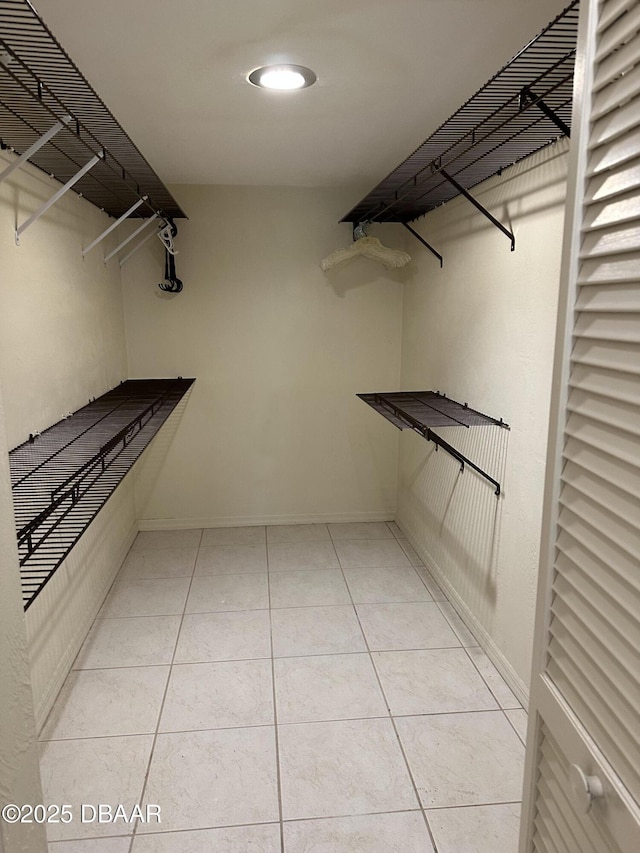 spacious closet featuring light tile patterned floors
