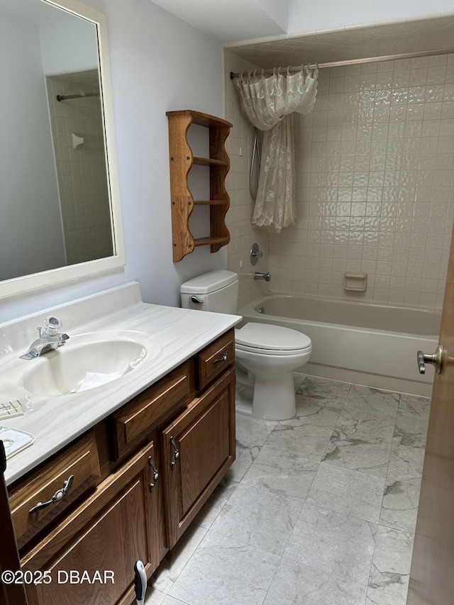 bathroom featuring marble finish floor, toilet, vanity, and bathing tub / shower combination