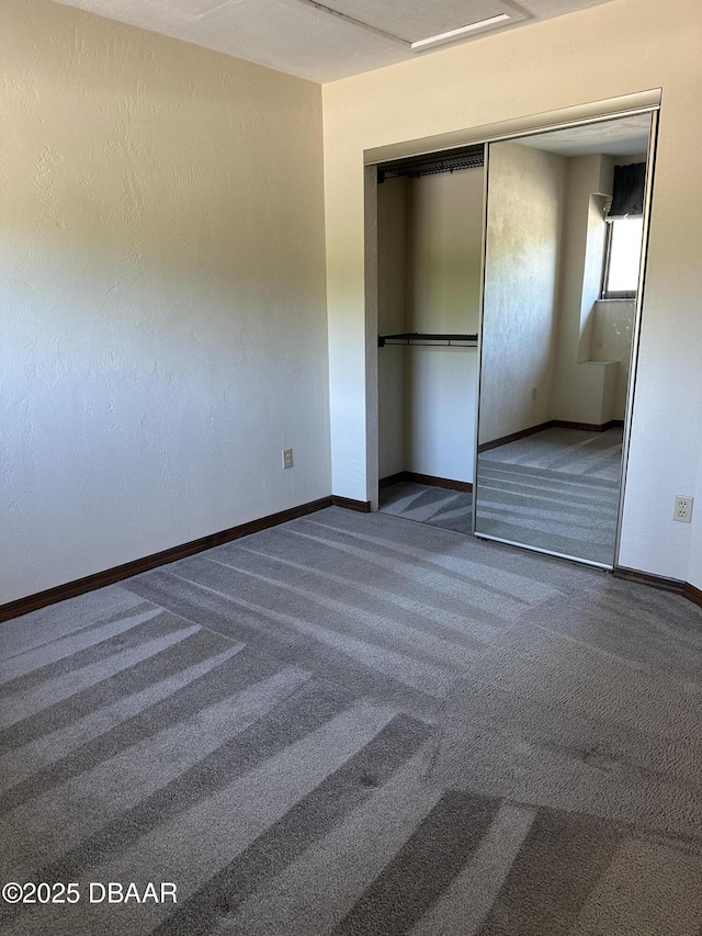 unfurnished bedroom featuring a closet, carpet flooring, and baseboards
